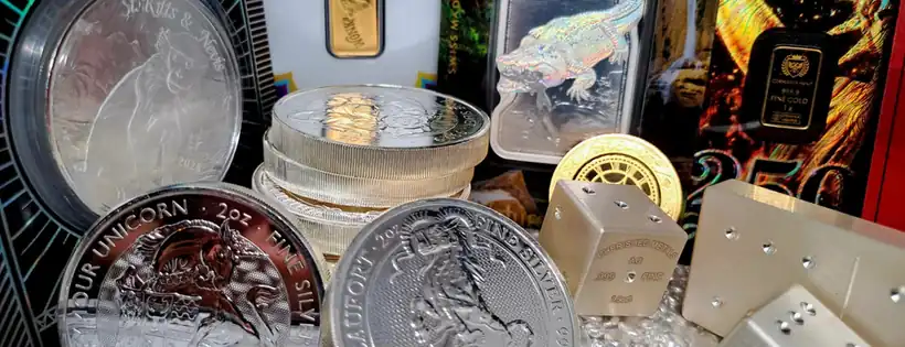 Silver and gold coins, bars and dice